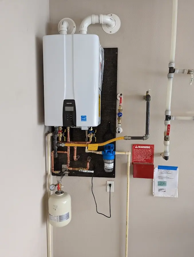 Professional plumber installing copper piping in a DeRidder home